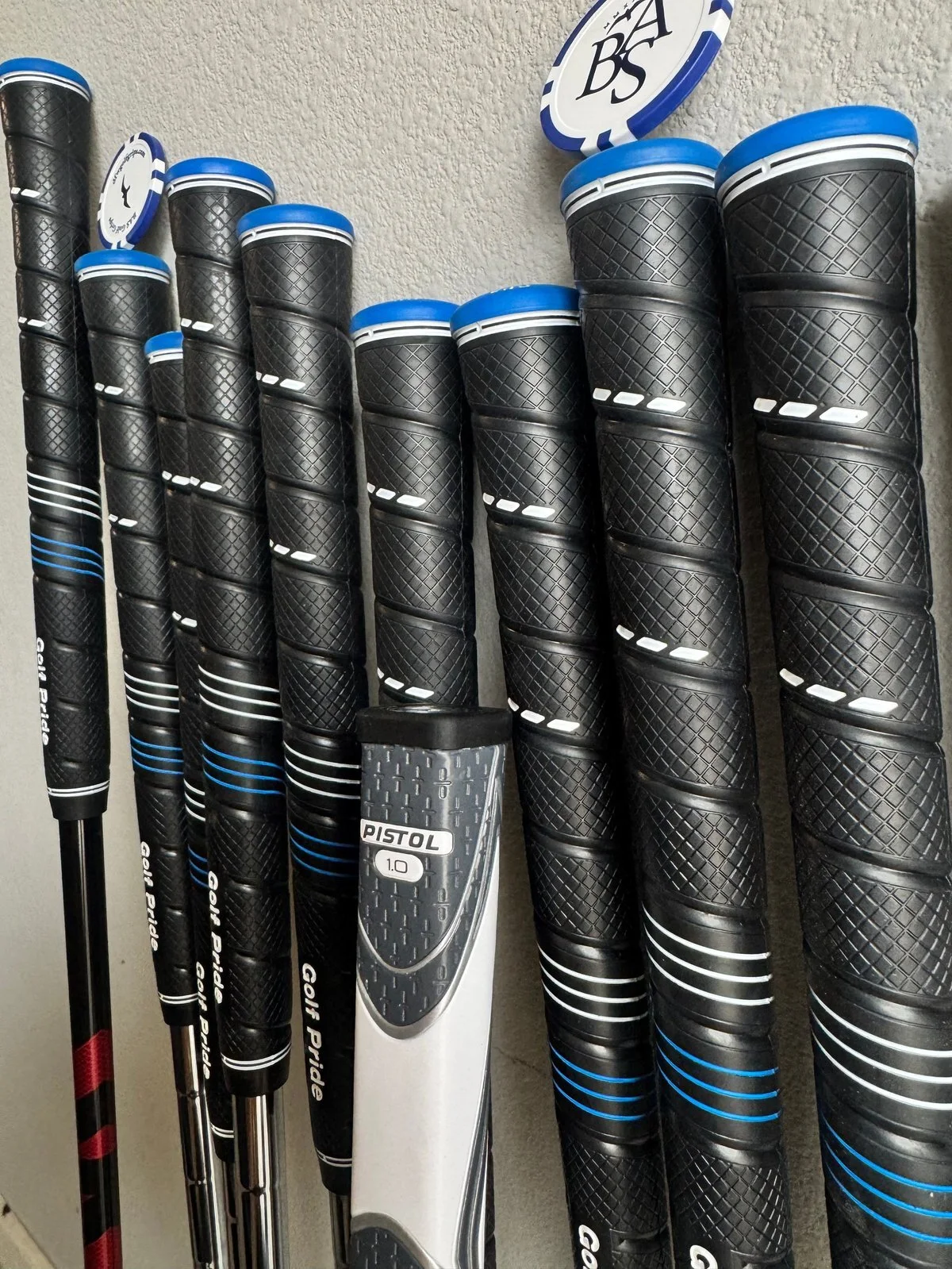 Completed black grips and putter grip installed on a golf club set