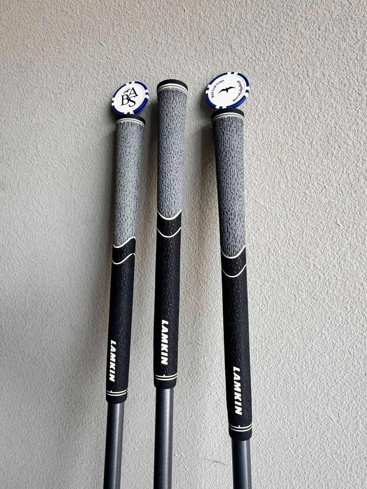 Completed black and gray Lamkin grips installed on golf clubs