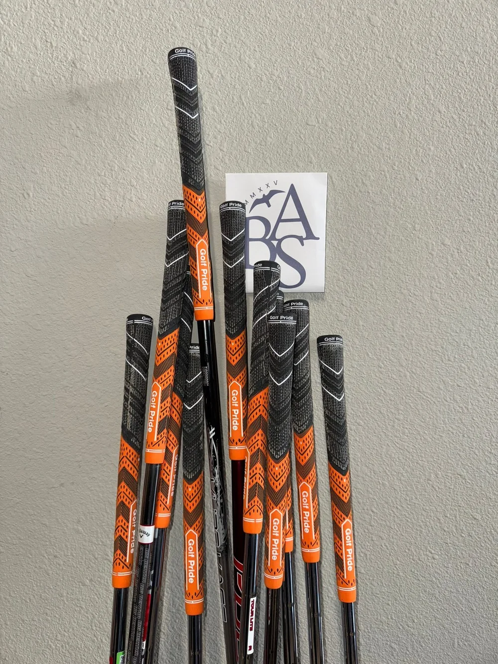 Completed gray and black hybrid grips installed across a club set