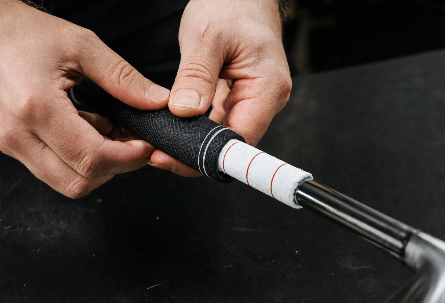 Golf grip being installed onto a club shaft